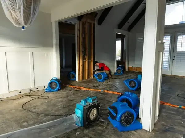 Air movers drying an open-plan room in a Decatur home after a water loss